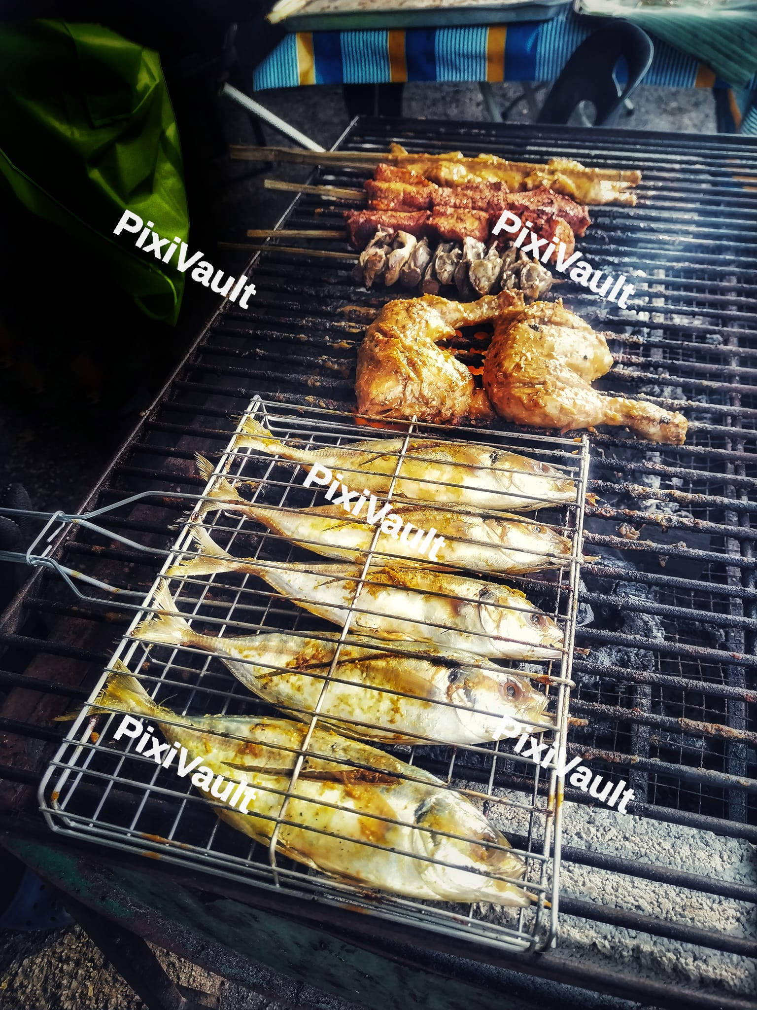 Fish and chicken pieces on a grill